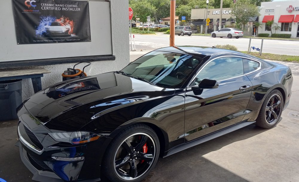 Black Ford Mustang with glossy mirror-finish paint
